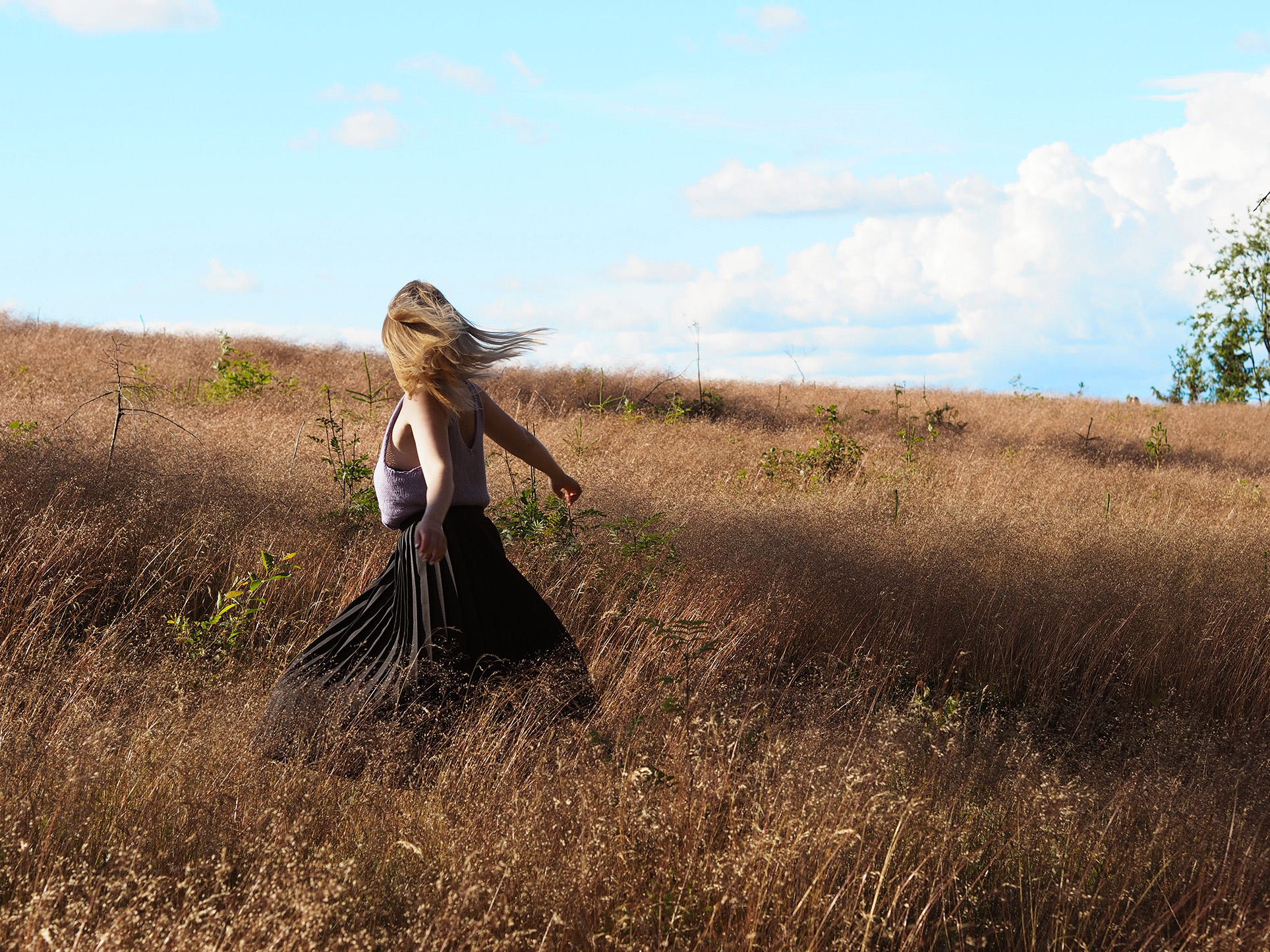 Spinning in my black pleated skirt